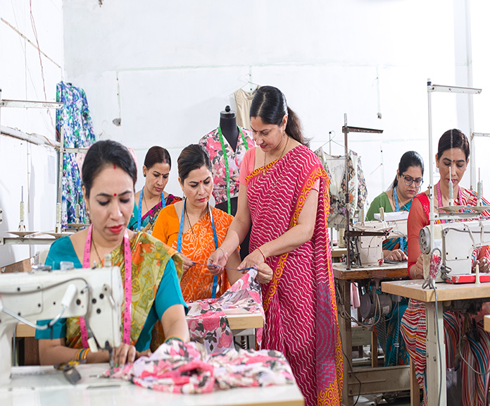 Woman,Textile,Worker,Checking,Garment,Stock,At,Factory