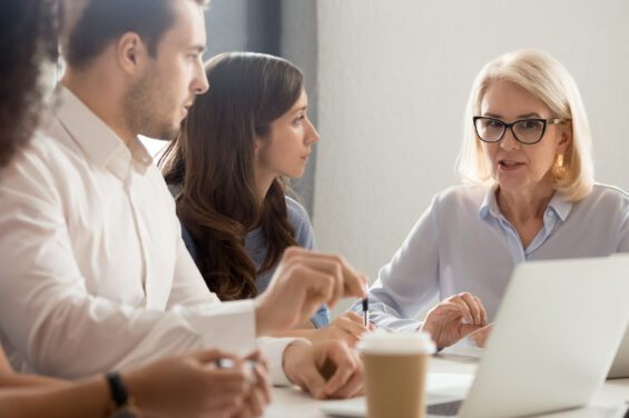 Diverse,Employees,Listening,To,Serious,Mature,Team,Leader,At,Office