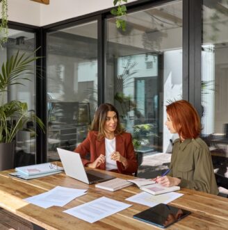 Two,Busy,Business,Women,Of,Young,And,Middle,Age,Talking