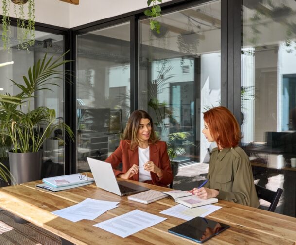 Two,Busy,Business,Women,Of,Young,And,Middle,Age,Talking