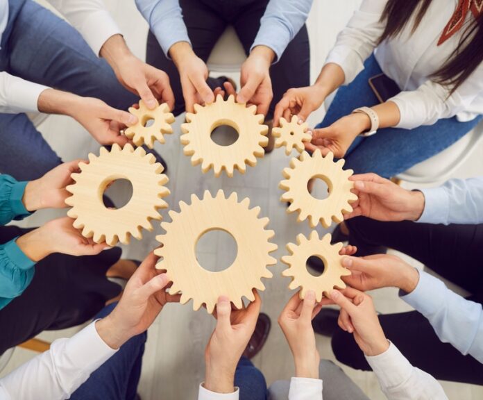 Top,View,Hands,Of,Group,Of,Business,People,Holding,Big
